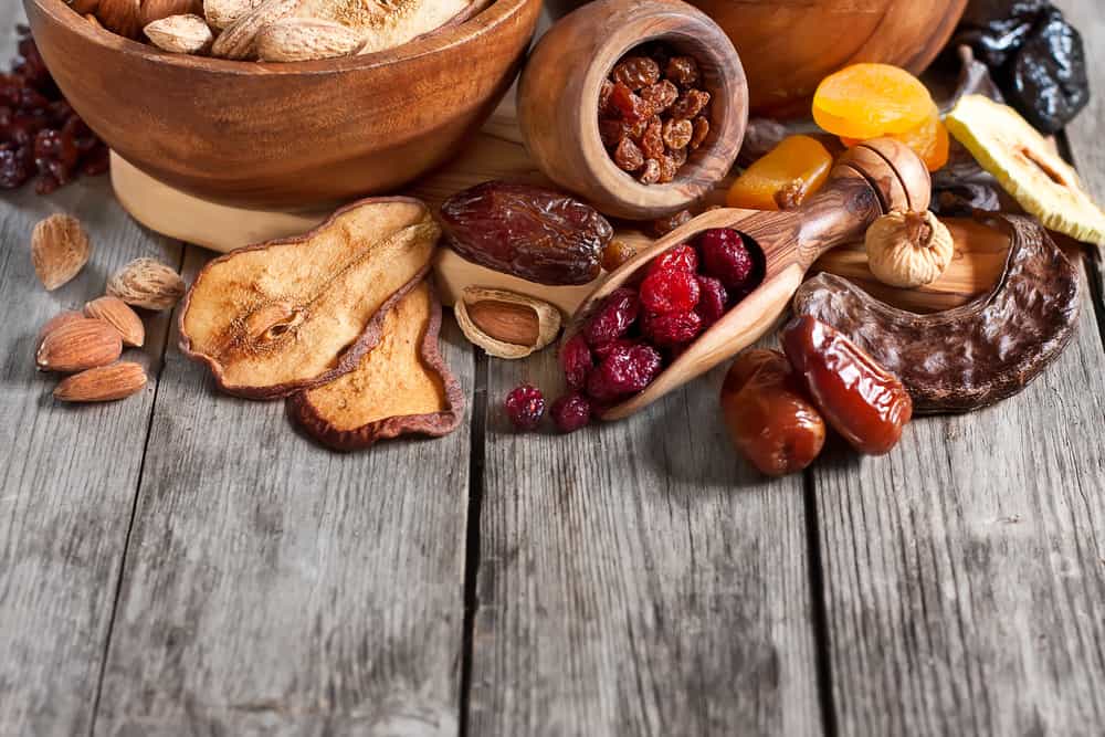 Mix of dried fruits and almonds - symbols of judaic holiday Tu Bishvat. Copyspace background.