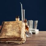 Vintage medicine bottles and books on wooden table